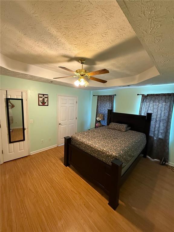 2851 Stanton Road Southeast Conyers, GA 30094 - Photo 8 of 11 a bedroom with a bed and a chandelier