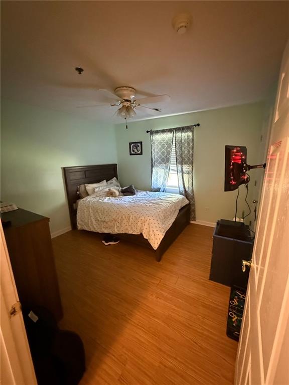 2851 Stanton Road Southeast Conyers, GA 30094 - Photo 9 of 11 a bedroom with a bed and wooden floor