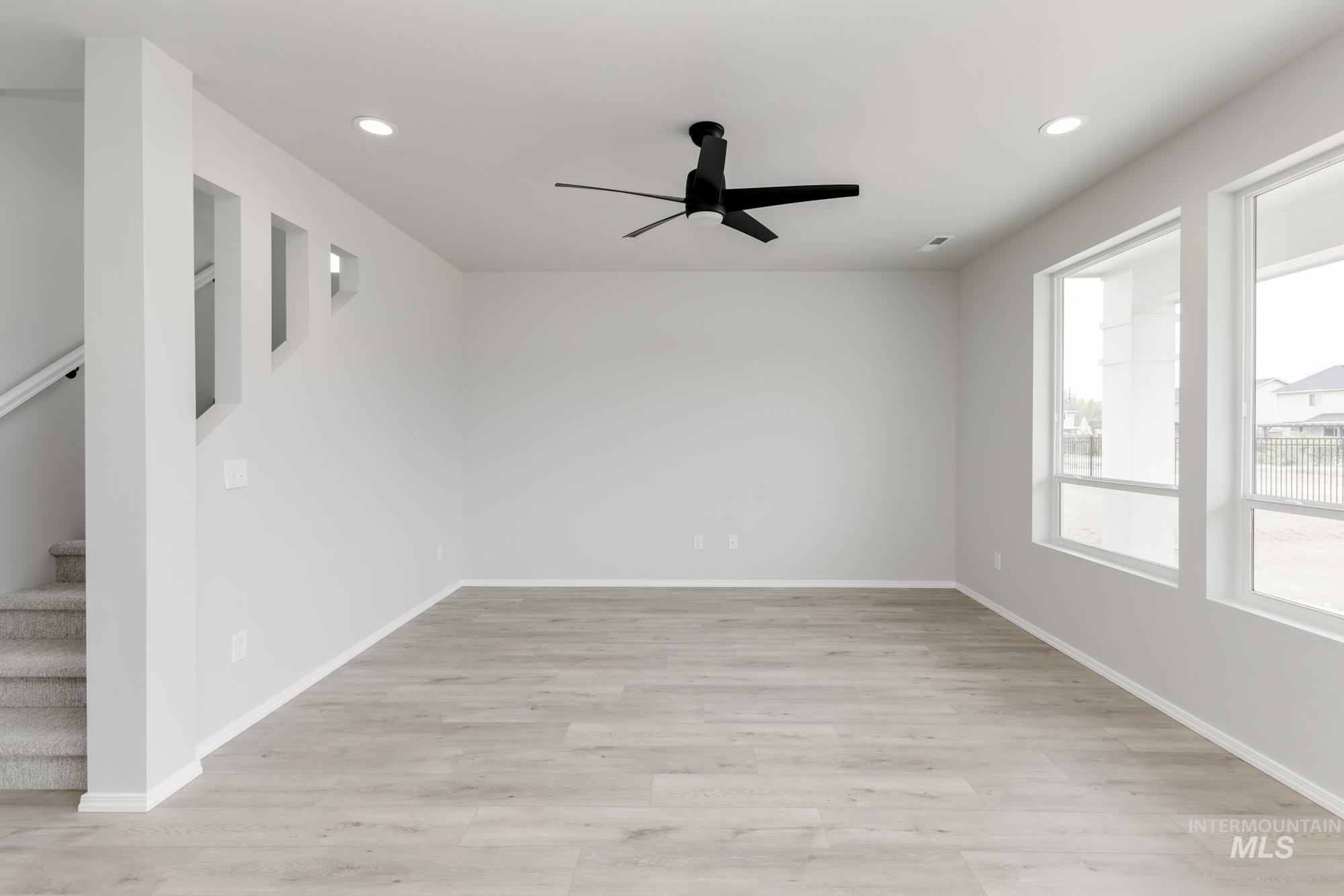 12842 Ropers Street Nampa, ID 83651 - Photo 11 of 29 Spacious interior featuring wood-finish flooring, recessed lighting, and a modern ceiling fan