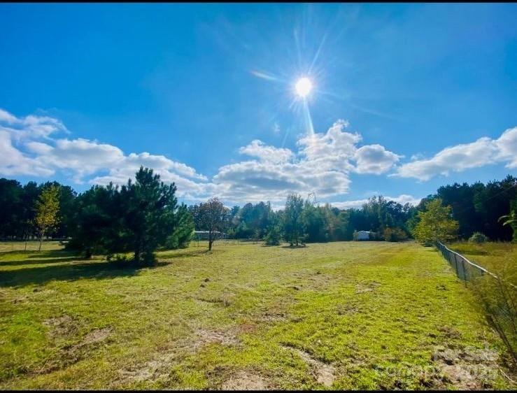 536 Mount Zion Church Road Maxton, NC 28364 - Photo 2 of 3 a view of swimming pool in middle of the green field