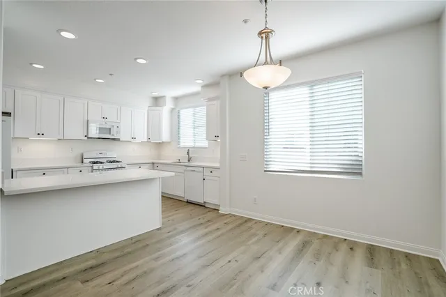 a kitchen with a sink window and cabinets