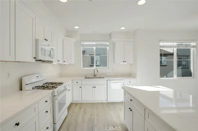 a kitchen with a sink stove and cabinets