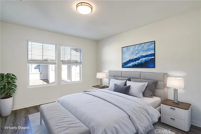 a bedroom with bed lamp and window
