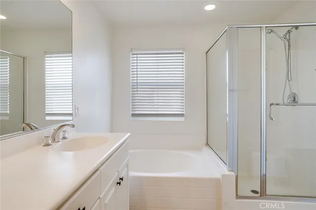 a bathroom with a bathtub a sink and a window