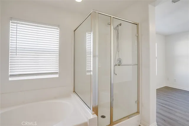 a bathroom with a bathtub and a shower