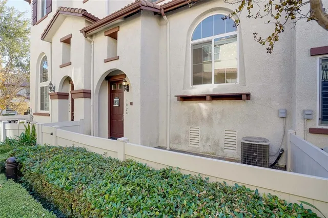 a front view of a house with many windows