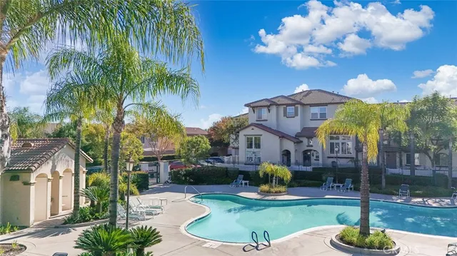 a swimming pool with outdoor seating and yard