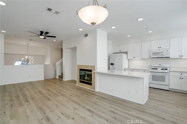 a view of kitchen with sink microwave and cabinets