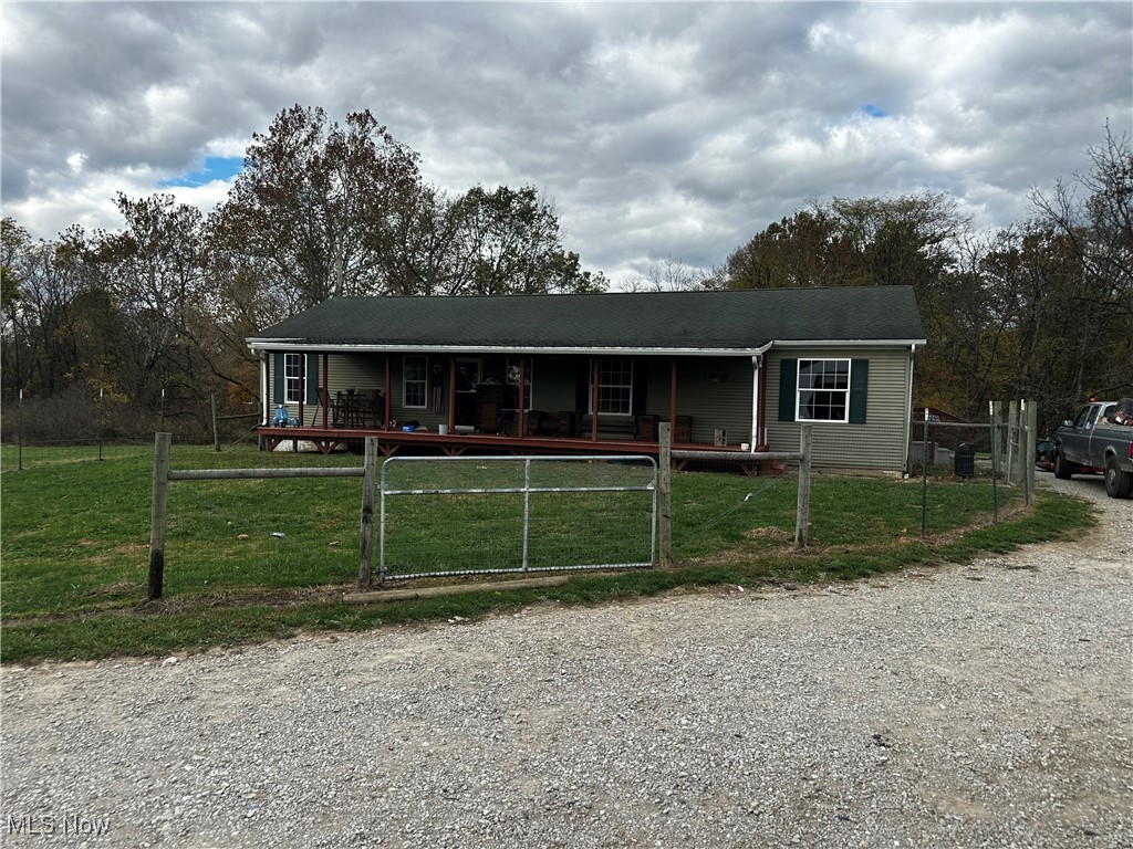 13891 George Ice Road Glenford, OH 43739 - Photo 1 of 1 View of front facade with a fenced front yard, covered porch, and a gate