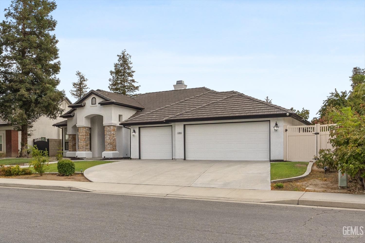 Undisclosed Address Bakersfield, CA 93311 - Photo 12 of 67 a front view of a house with a yard and garage