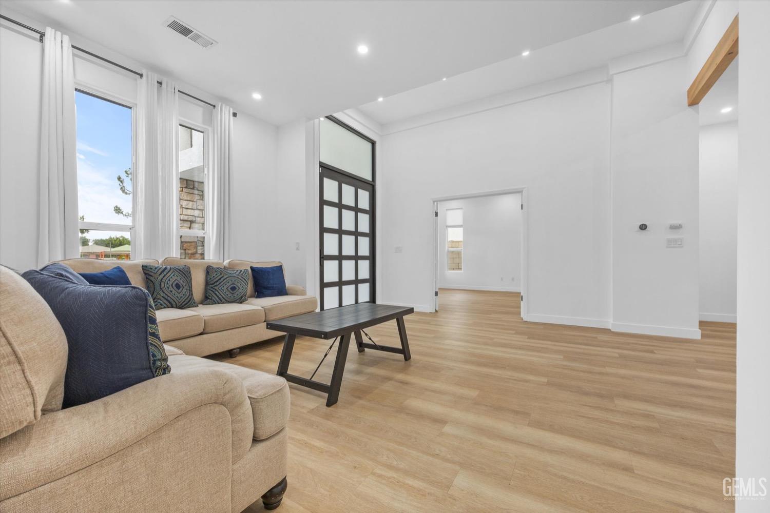 Undisclosed Address Bakersfield, CA 93311 - Photo 17 of 67 a living room with furniture and wooden floor
