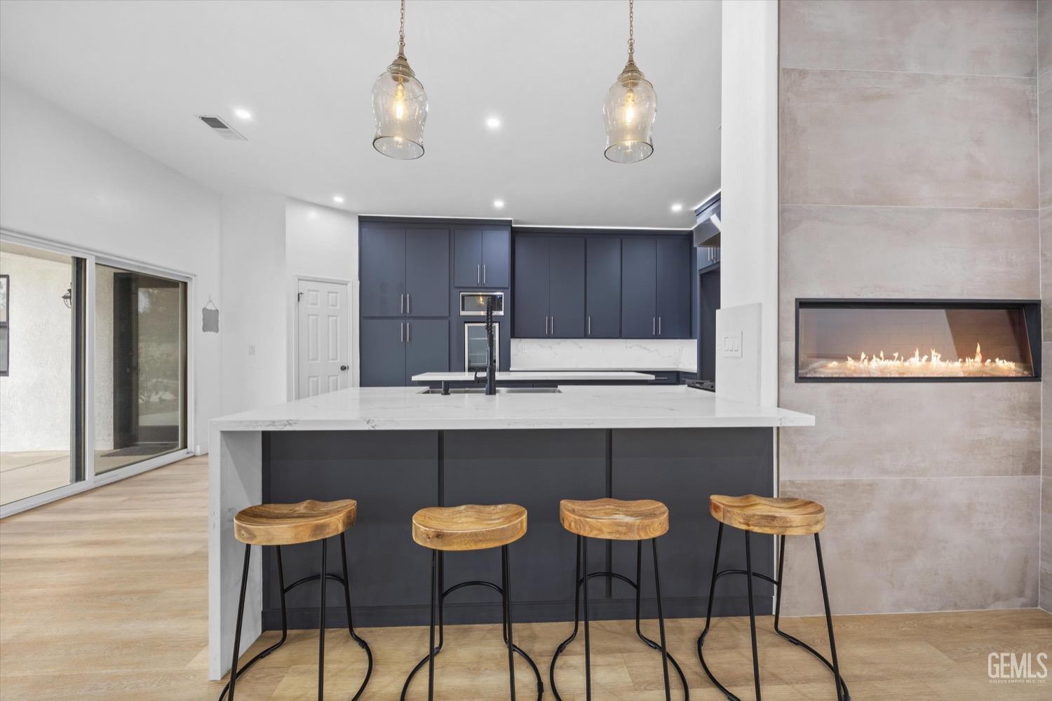 Undisclosed Address Bakersfield, CA 93311 - Photo 23 of 67 a kitchen with a table chairs refrigerator and cabinets