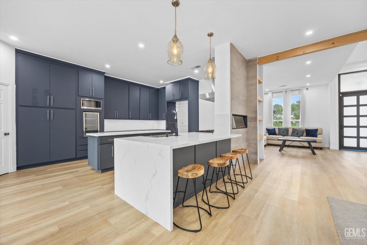 Undisclosed Address Bakersfield, CA 93311 - Photo 26 of 67 a kitchen with stainless steel appliances granite countertop a refrigerator a sink dishwasher a stove and a dining table with wooden floor