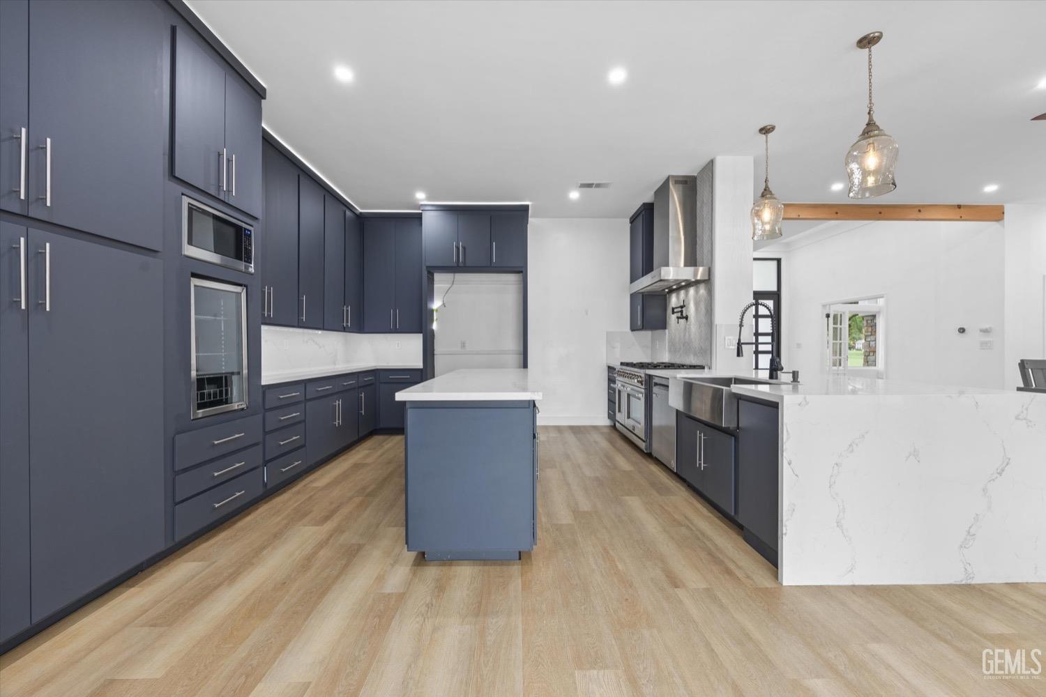 Undisclosed Address Bakersfield, CA 93311 - Photo 27 of 67 a large kitchen with stainless steel appliances a large counter top a oven a stove and a refrigerator