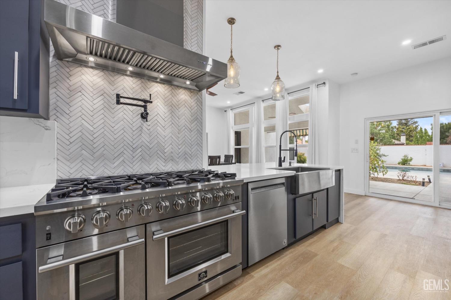 Undisclosed Address Bakersfield, CA 93311 - Photo 28 of 67 a kitchen with stainless steel appliances granite countertop a stove and a sink