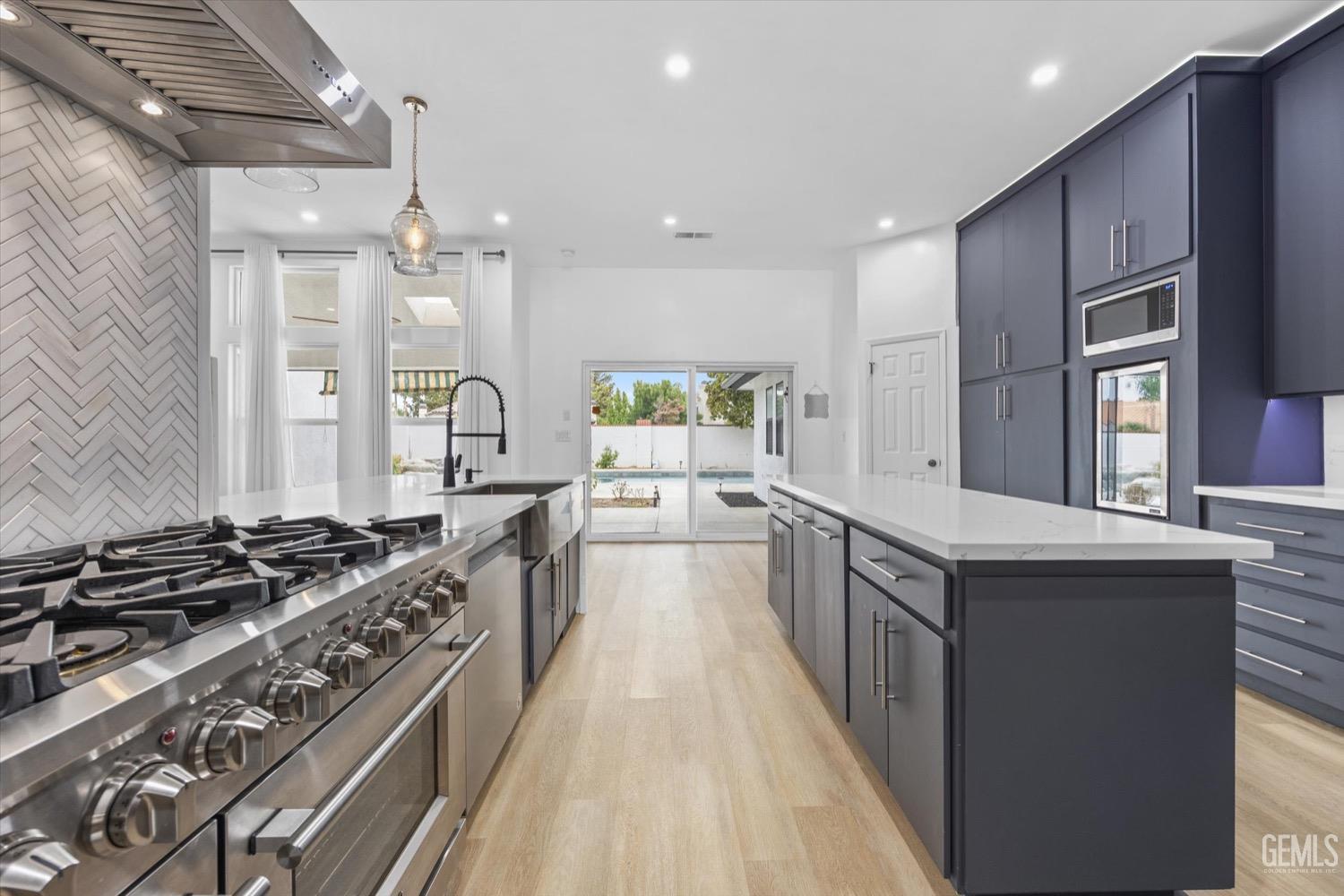 Undisclosed Address Bakersfield, CA 93311 - Photo 33 of 67 a kitchen with stainless steel appliances a stove a sink dishwasher and a refrigerator