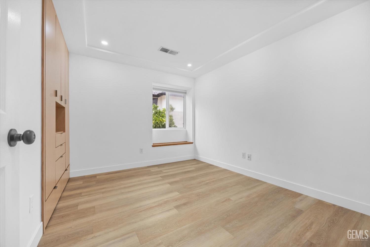 Undisclosed Address Bakersfield, CA 93311 - Photo 43 of 67 wooden floor in an empty room with a window