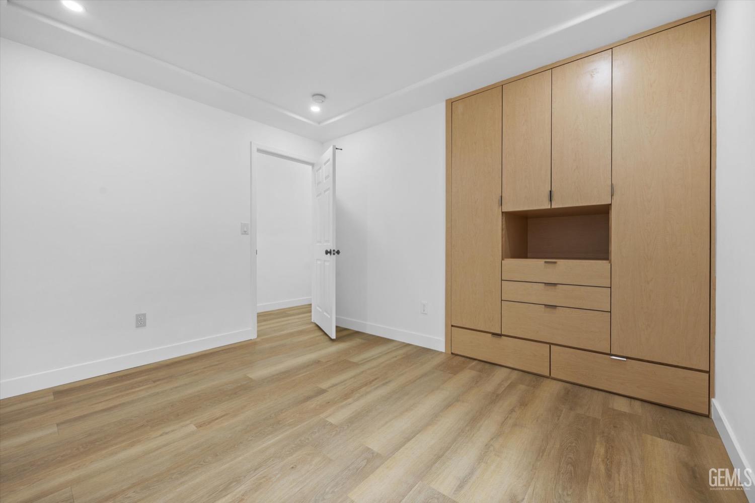 Undisclosed Address Bakersfield, CA 93311 - Photo 44 of 67 a view of an empty room with wooden floor