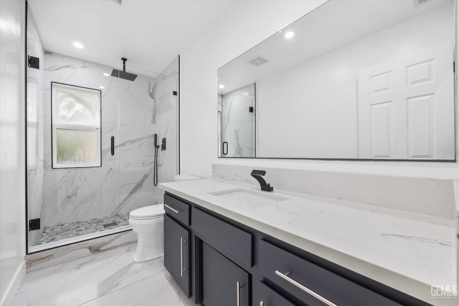 Undisclosed Address Bakersfield, CA 93311 - Photo 45 of 67 a bathroom with a granite countertop sink a toilet and shower