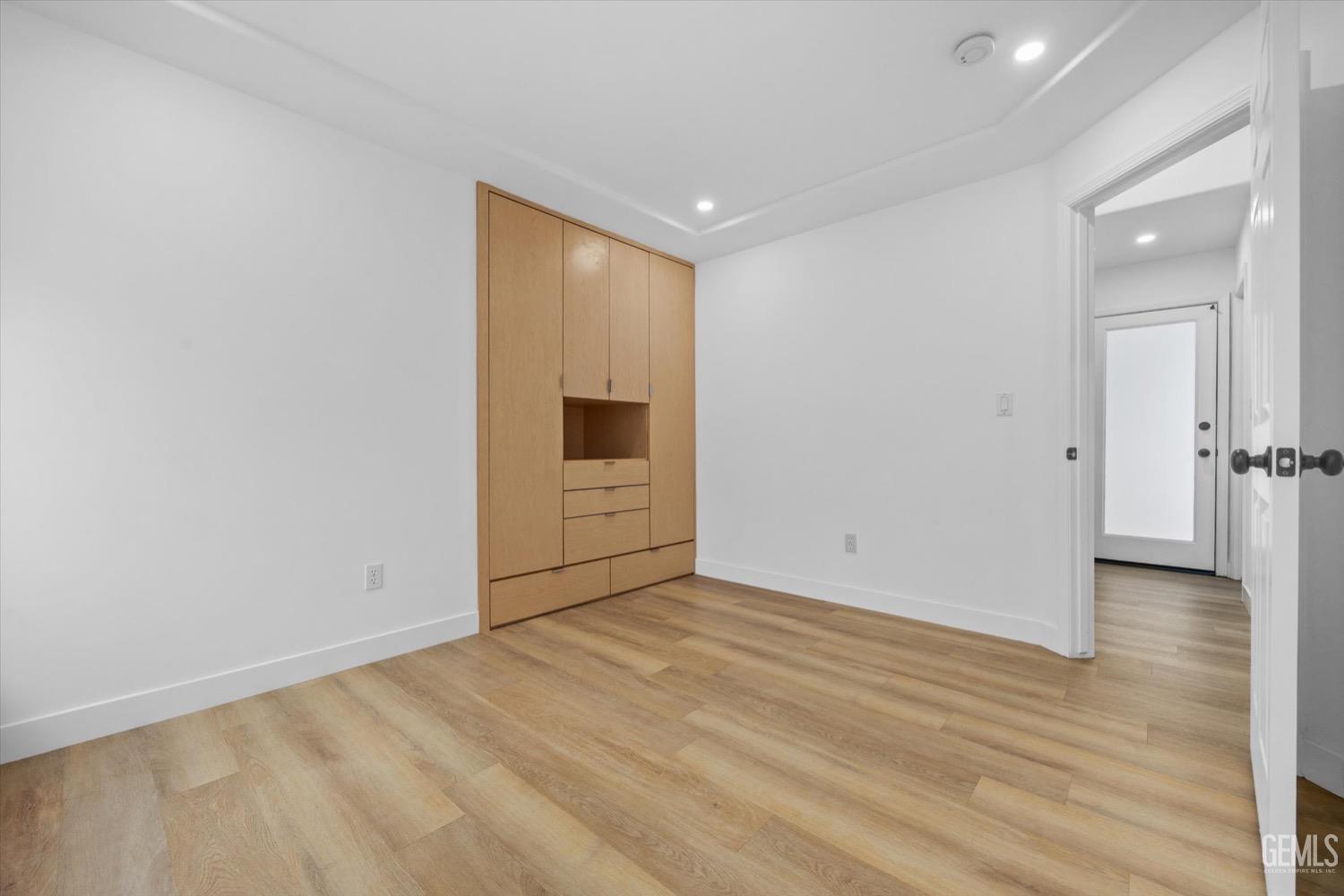 Undisclosed Address Bakersfield, CA 93311 - Photo 49 of 67 a view of a room with wooden floor and a hallway