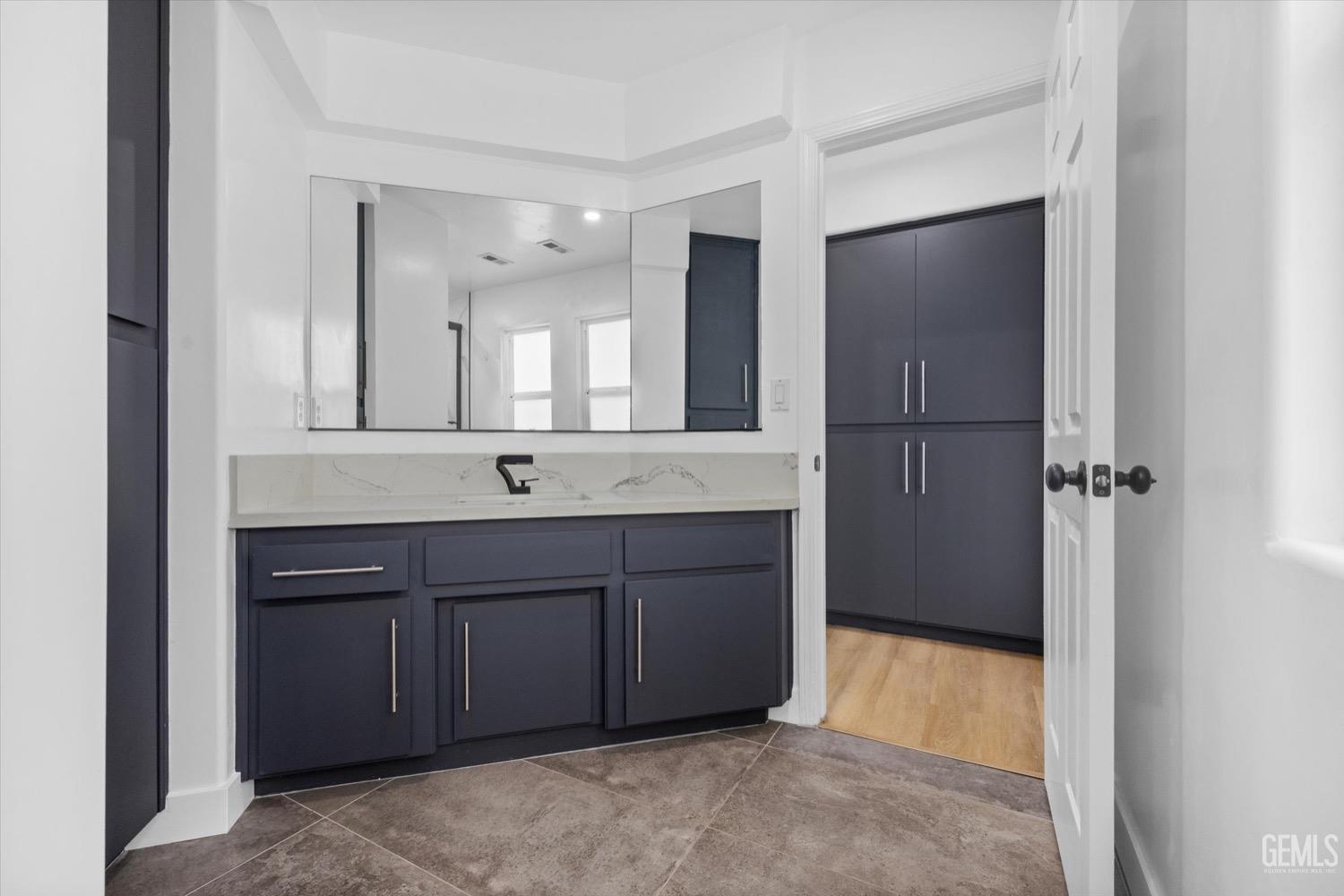Undisclosed Address Bakersfield, CA 93311 - Photo 51 of 67 a bathroom with a granite countertop sink and mirror