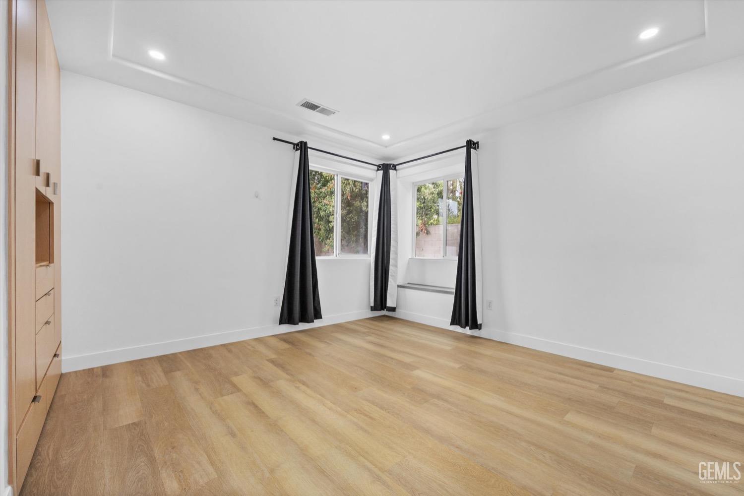 Undisclosed Address Bakersfield, CA 93311 - Photo 53 of 67 a big room with wooden floor and windows