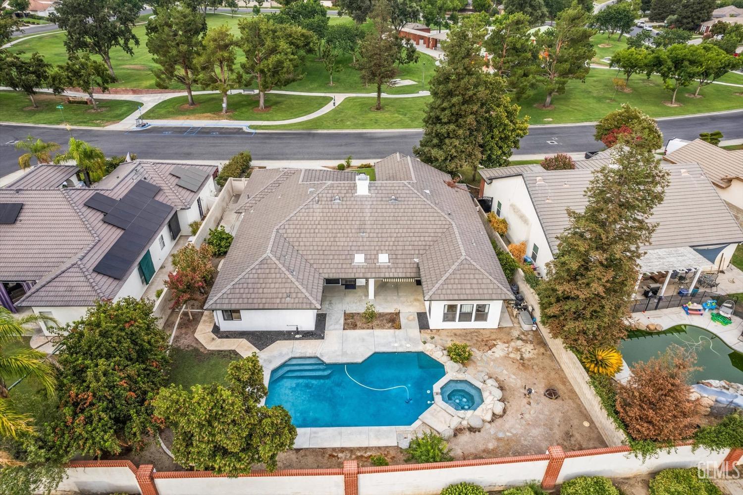 Undisclosed Address Bakersfield, CA 93311 - Photo 7 of 67 an aerial view of a house with a garden and lake view