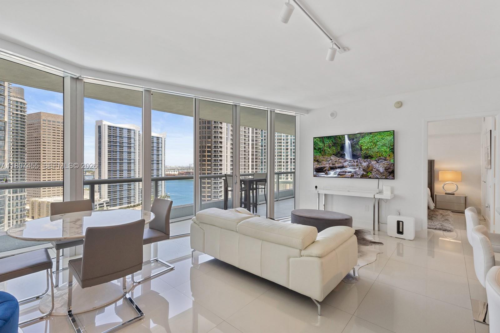 495 Brickell Avenue, Unit 2304 Miami, FL 33131 - Photo 2 of 29 a living room with furniture and a large window