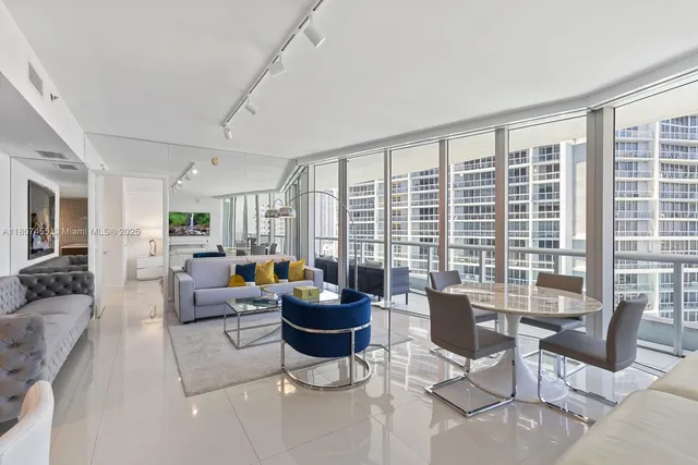 a living room with furniture and large windows