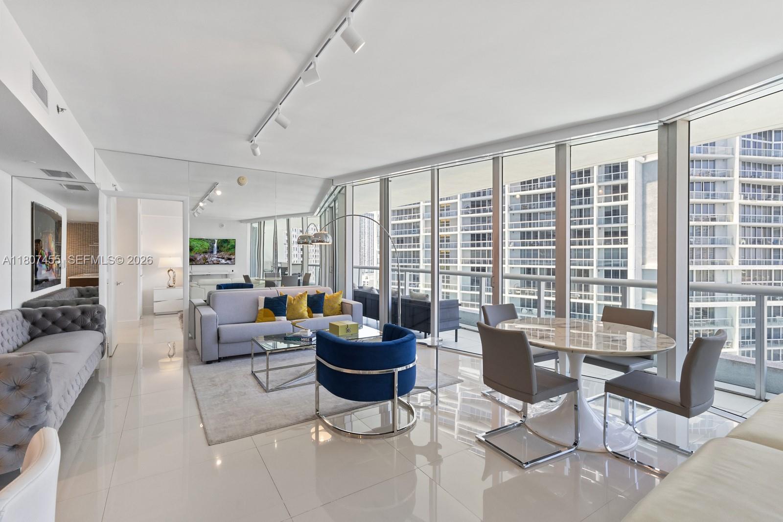 495 Brickell Avenue, Unit 2304 Miami, FL 33131 - Photo 4 of 29 a living room with furniture and large windows