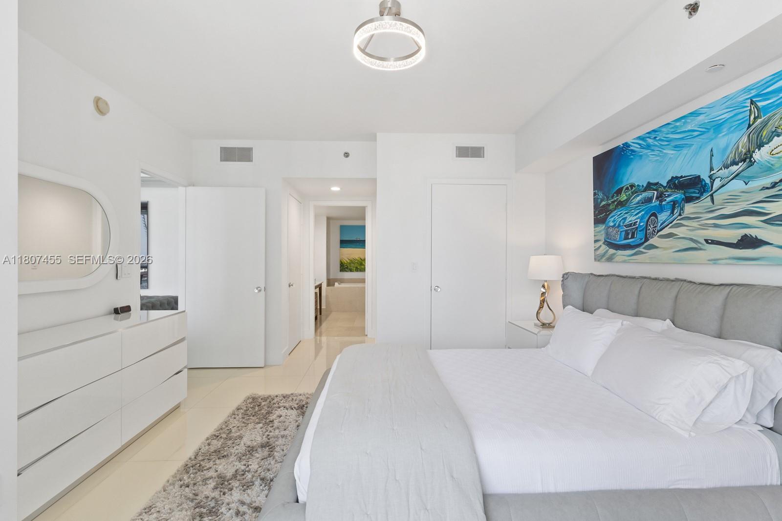 495 Brickell Avenue, Unit 2304 Miami, FL 33131 - Photo 9 of 29 a bedroom with a bed and a painting on the wall