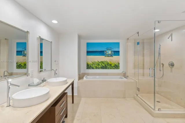 a bathroom with a bathtub shower sink and mirror