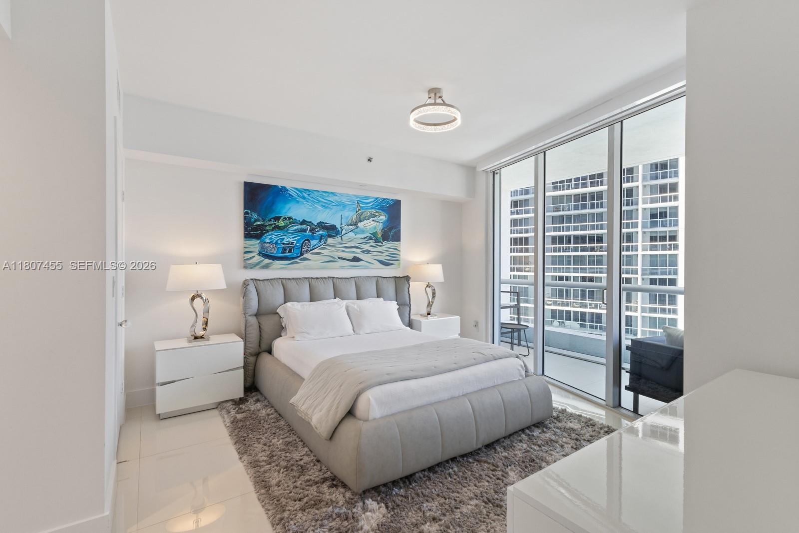 495 Brickell Avenue, Unit 2304 Miami, FL 33131 - Photo 10 of 29 a bedroom with a bed and a large window