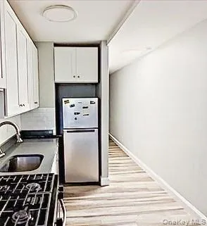 a kitchen with a refrigerator and a sink