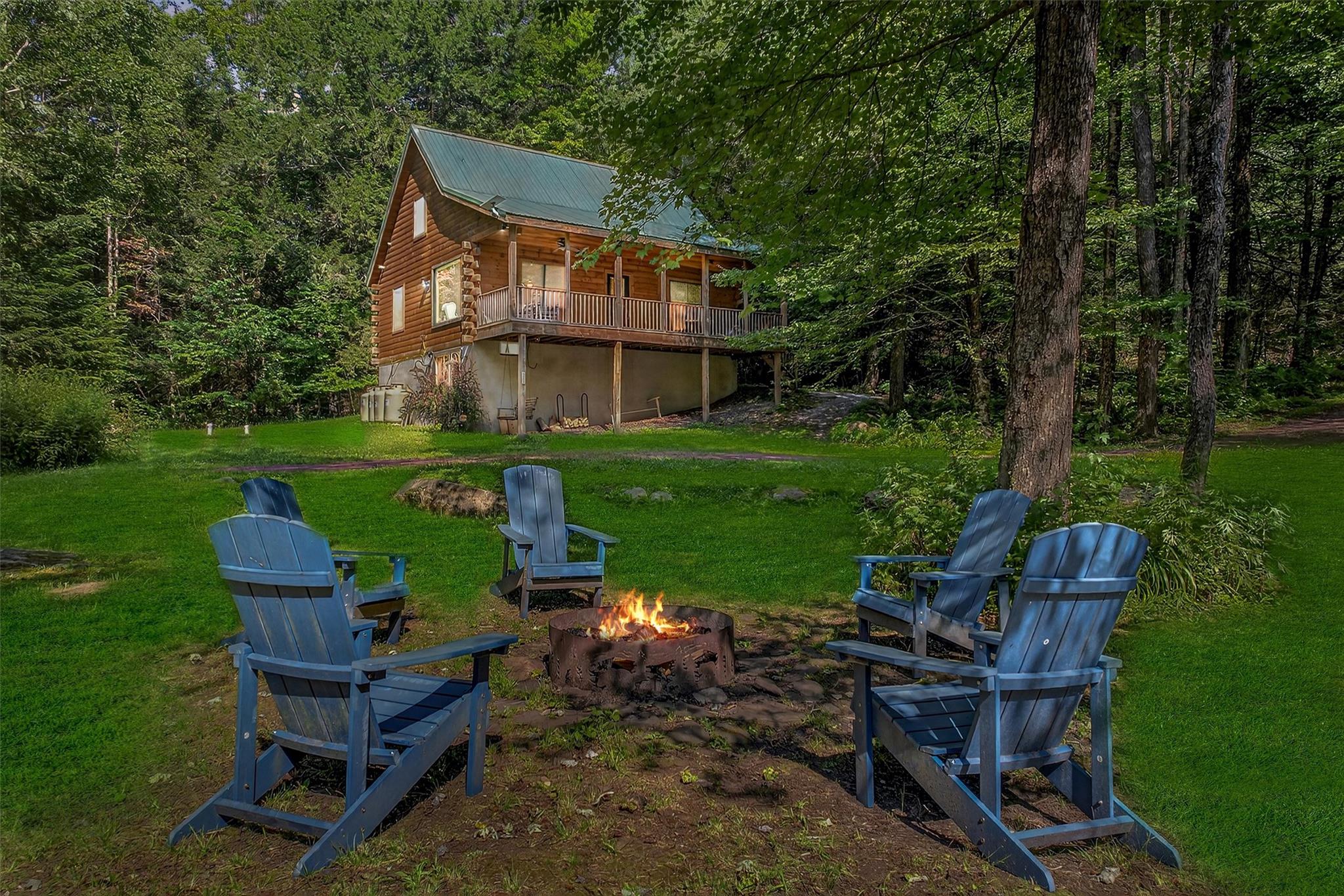 a front view of a house with garden and sitting area