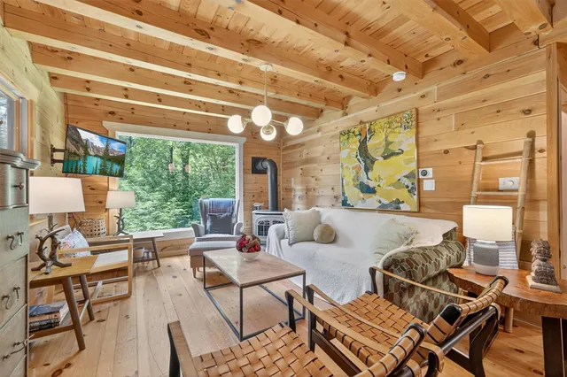 a living room with lots of furniture and wooden floor