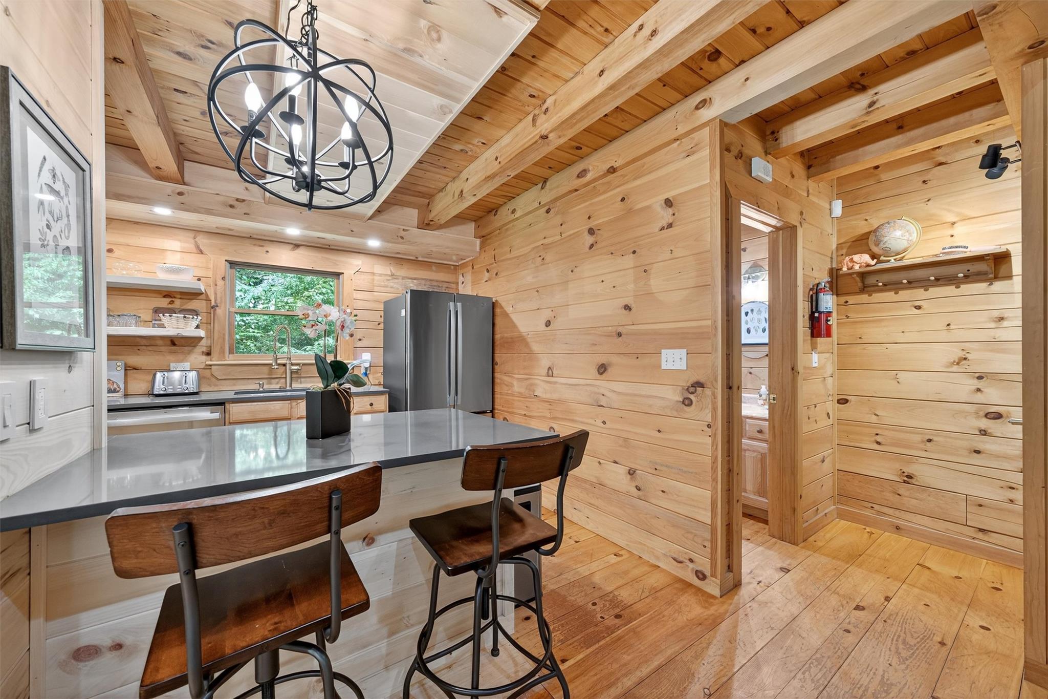 353 John Davis Road Beach Lake, PA 18405 - Photo 17 of 50 a room with stainless steel appliances kitchen island granite countertop a table chairs in it and wooden floor