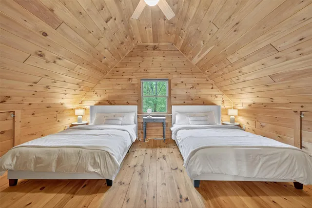 a bedroom with a bed and a mirror