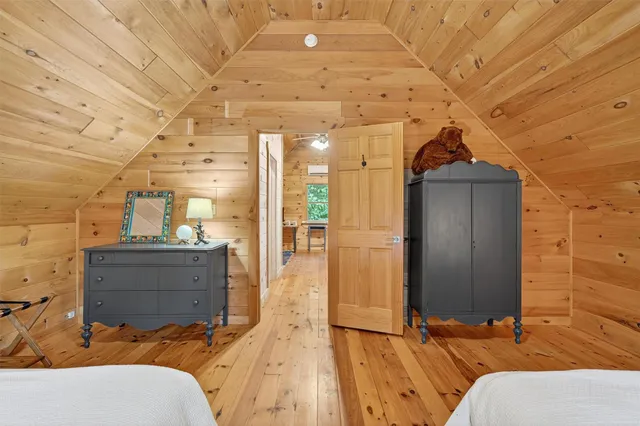 a bedroom with two beds and a lamp