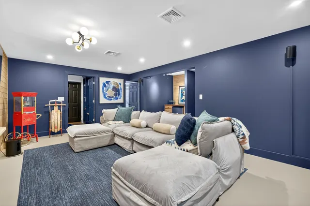 a living room with furniture and stairs