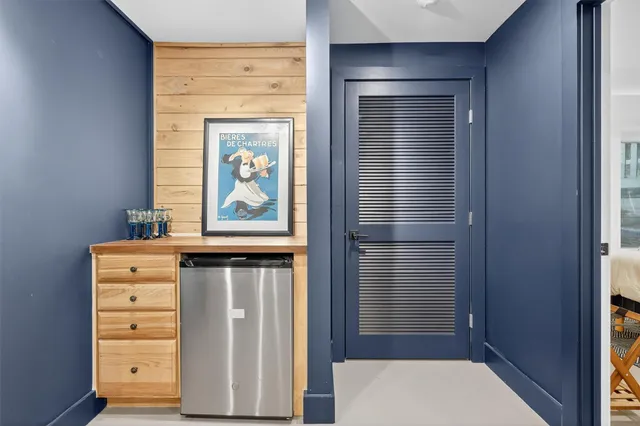 a bedroom with a bed and painting on the wall