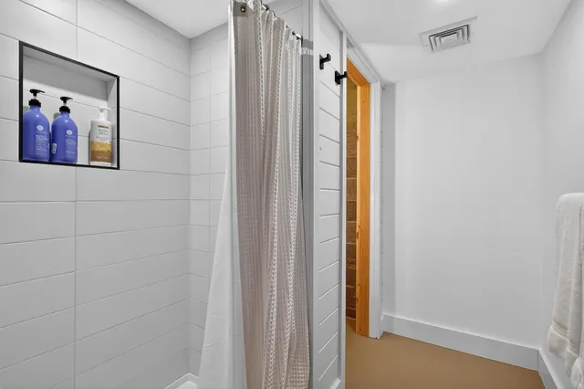 a bathroom with a toilet sink and shower