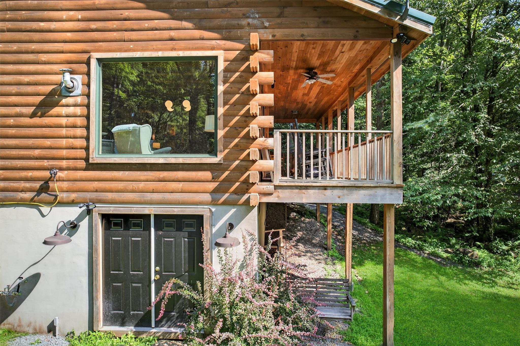 353 John Davis Road Beach Lake, PA 18405 - Photo 41 of 50 a balcony with lots of green space and glass windows
