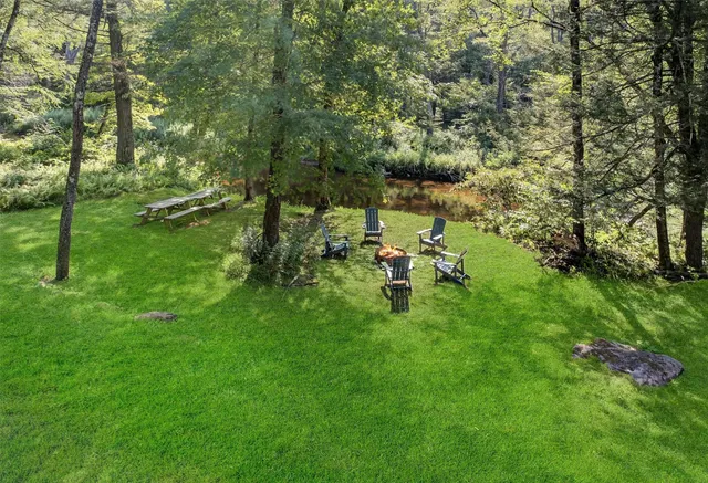 an aerial view of a house with a yard