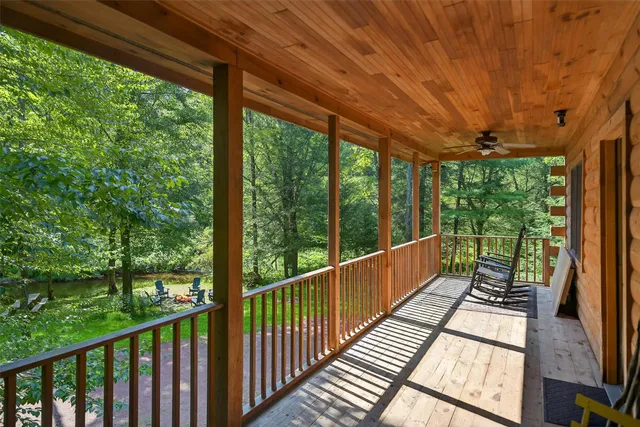 a view of balcony with deck and trees