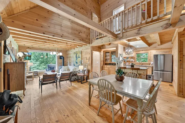 a view of a dining room with furniture wooden floor and a chandelier