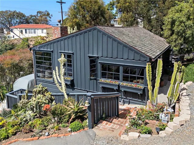 a house with lots of trees in the background