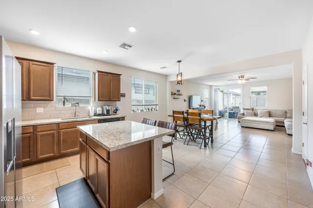 a kitchen with stainless steel appliances kitchen island granite countertop a sink and cabinets