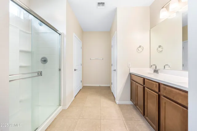 a spacious bedroom with a bed and ceiling fan