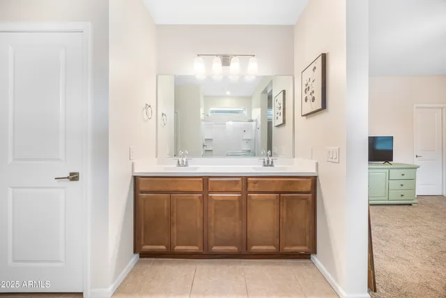 a bedroom with a bed a flat screen tv and a couch